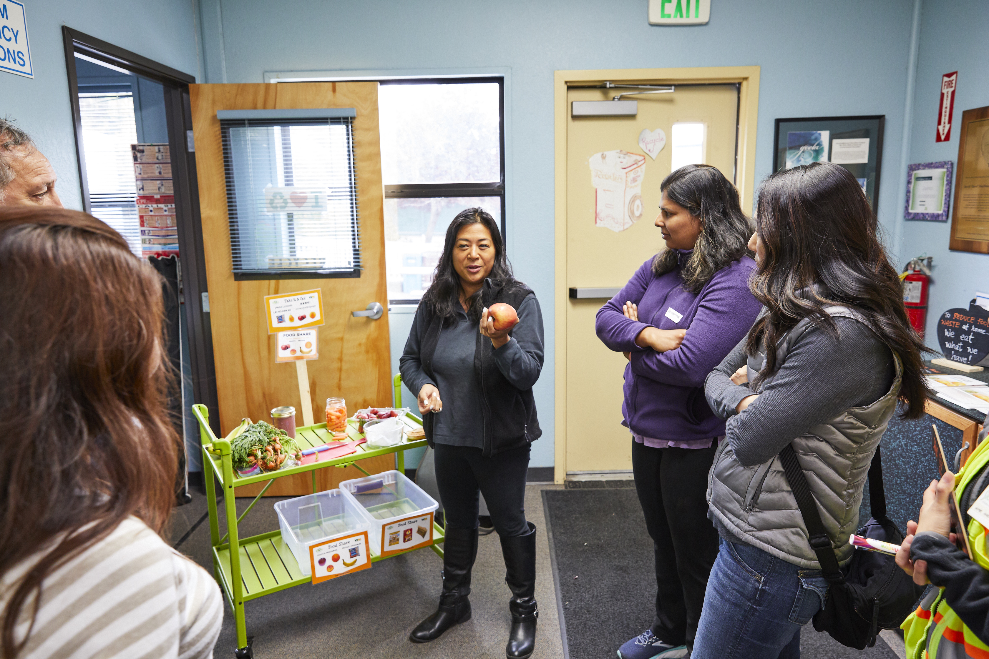 Chaperones and teachers learning about food share during the field trip program